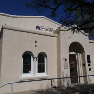 A view of a simple yet elegant architectural building with arched windows and a welcoming entrance.