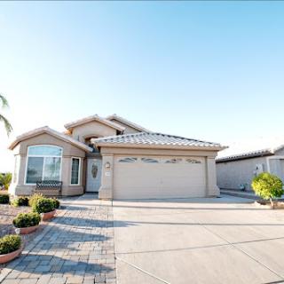 A beautiful residential home with a well-maintained driveway and landscaping.