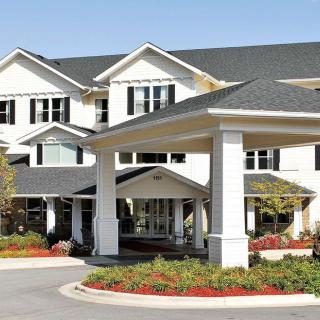 A modern residential building with a landscaped entrance.