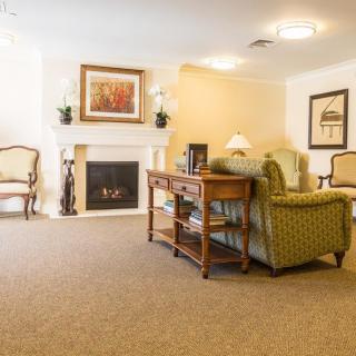 A cozy living room with traditional decor featuring a fireplace and comfortable seating.