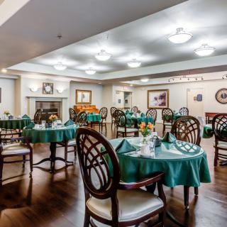 An elegant dining area with neatly arranged tables and chairs, featuring a warm and inviting interior design.