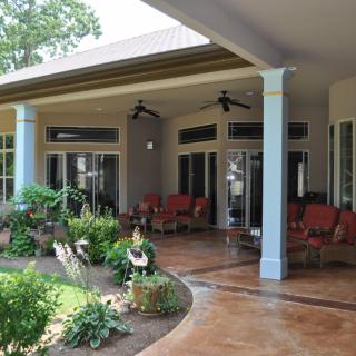 A cozy patio with comfortable seating and lush garden views.