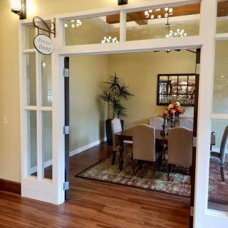 A cozy dining room with elegant decor, featuring a large dining table and stylish chairs.