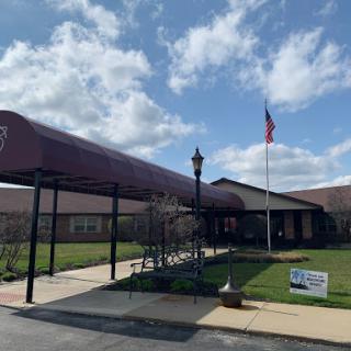 A welcoming entrance featuring a flag and clear blue skies.