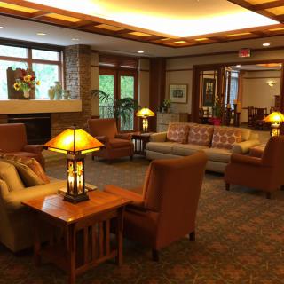A cozy lobby area featuring comfortable sofas, armchairs, and warm lighting.