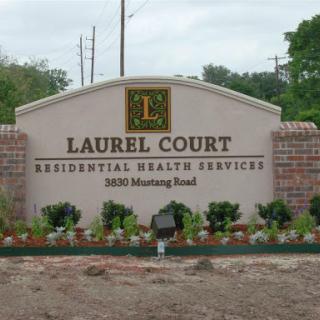 The entrance sign for Laurel Court Residential Health Services located on Mustang Road.