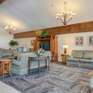 A spacious lobby area with comfortable sofas, elegant chandeliers, and tasteful decor.