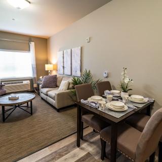 A modern apartment with a cozy living room and dining area.