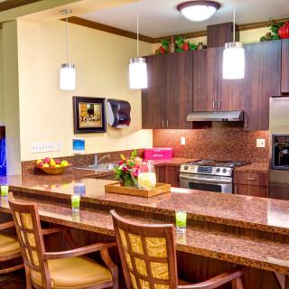 A modern kitchen with a sleek countertop and stylish pendant lights.
