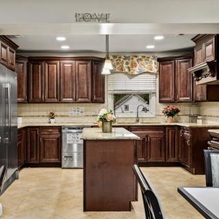 A modern kitchen with wooden cabinets and stainless steel appliances.