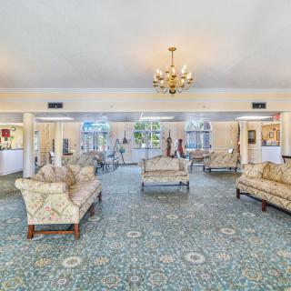Elegant hotel lobby with classic sofas and a chandelier.