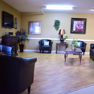 A cozy living room space featuring comfortable seating and decorative elements.
