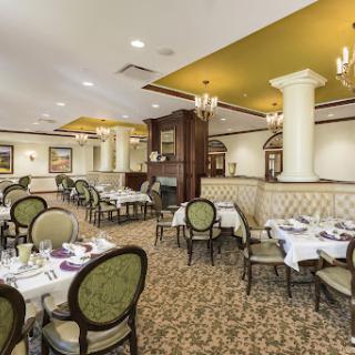 An elegant dining area showcasing an inviting atmosphere with carefully arranged tables and luxurious furnishings.