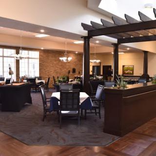 A spacious and inviting dining area in a restaurant featuring modern furniture and warm lighting.