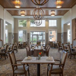 A well-appointed dining area featuring elegant tables and chairs, with modern lighting and decor.