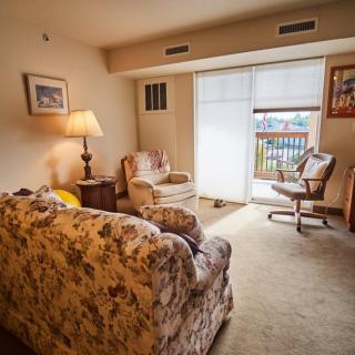 A cozy living room with floral patterned furniture and warm lighting.