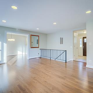 A bright and open living room with hardwood flooring and modern decor.