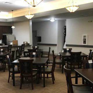 An empty dining area with neatly arranged tables and chairs.