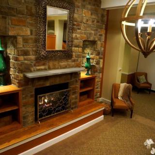 A cozy living room with a stone fireplace and elegant decor.