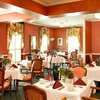 An elegant restaurant dining room with beautifully set tables and stylish decor.