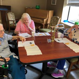 Seniors engaged in a group activity at their community center.