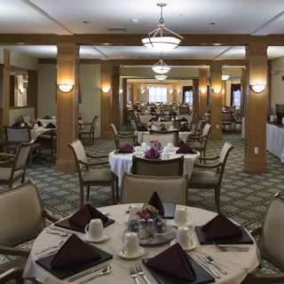 A spacious dining room with neatly arranged tables and chairs, ready for guests.
