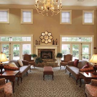 A luxurious living room with elegant furniture and a grand chandelier.