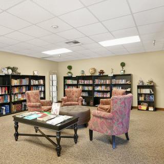 A cozy reading area with bookshelves and comfortable chairs.