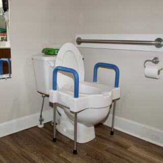 An accessible bathroom with supportive handrails and safety features.