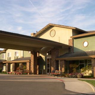 The exterior view of a modern building with a large entrance and covered walkway.