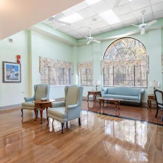 A bright and inviting waiting area featuring comfortable seating and large windows that allow natural light to fill the space.