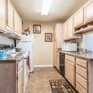 A well-organized kitchen with wooden cabinets and modern appliances.
