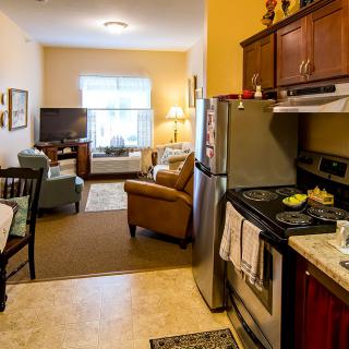 A cozy apartment with an open kitchen and living room area.