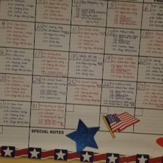 A colorful calendar with notes and a decorative American flag.