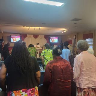 A community gathering in worship at a local church.