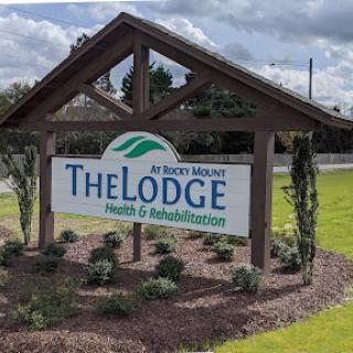 A welcoming sign for 'The Lodge' at Rocky Mount, highlighting health and rehabilitation services.
