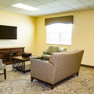 A cozy living room with modern furnishings and a large window.