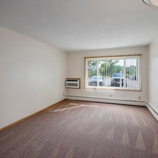 A spacious and bright living room with large windows, inviting natural light.