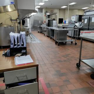 A spacious and organized commercial kitchen ready for food preparation.