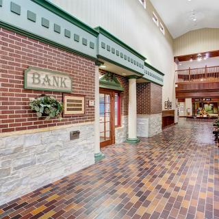 A bank interior featuring brick walls and a distinct architectural design.