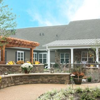 A beautiful house with a landscaped garden and patio area.