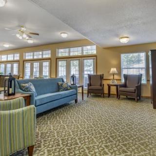 A cozy living room with comfortable seating and large windows.