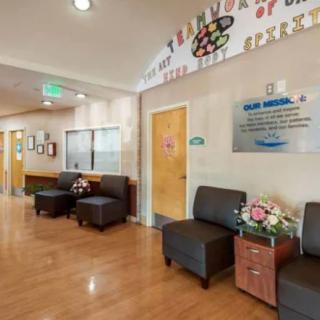 A hospital waiting area with comfortable seating and decorative elements.