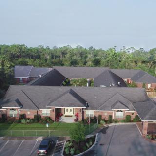 Aerial view of suburban residential buildings with neatly manicured lawns.