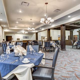Elegant dining room with neatly set tables and comfortable seating.
