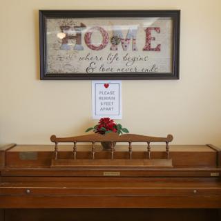 A cozy home entrance featuring decorative wall art and a wooden piece adorned with flowers.