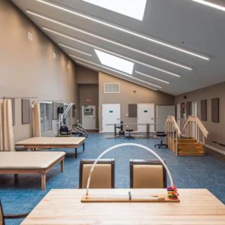 A spacious rehabilitation center equipped with exercise and physical therapy facilities.