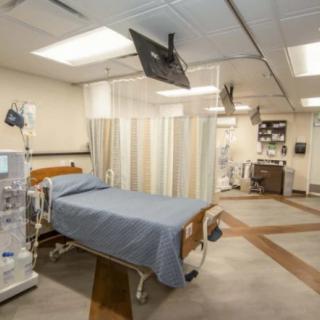 A hospital patient room equipped with medical facilities and a bed.