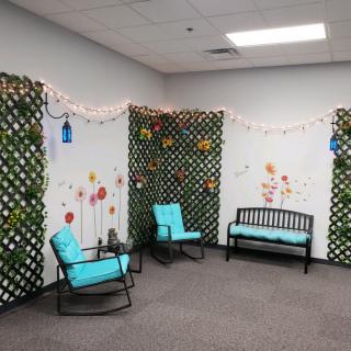 Cozy seating area with turquoise-cushioned furniture and decorative lattice walls adorned with string lights.
