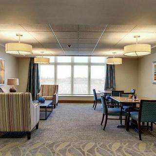 A spacious living room with comfortable seating and large windows.